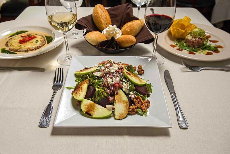 Salad with sliced apples, crushed walnuts and grated cheese